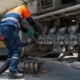 Driver hooking up hose to tank truck